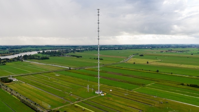 Drone view of an ICOS atmospheric tall tower among green fields
